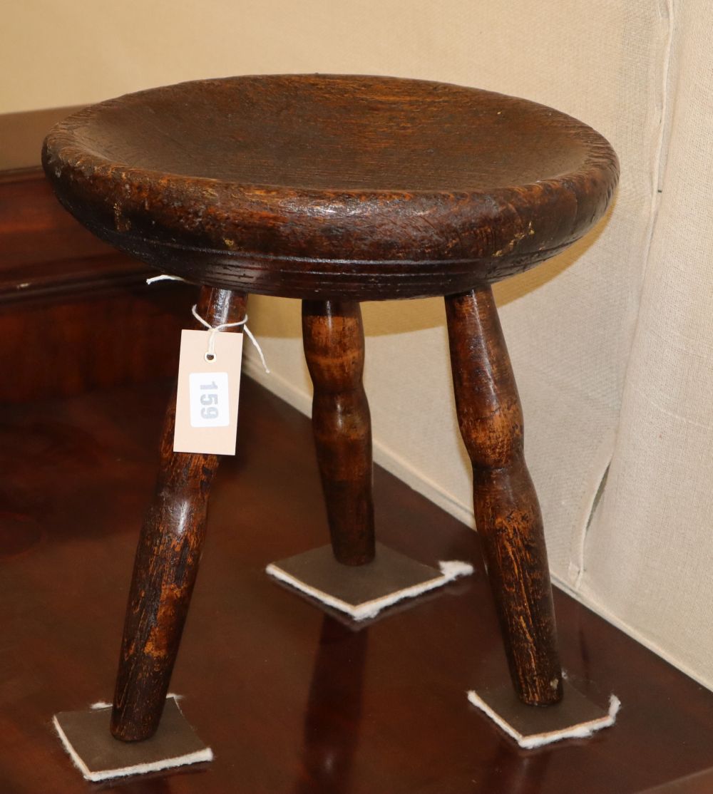 A round turned primitive pine stool with dish top, c.1840, 33cm diameter, H.36cm